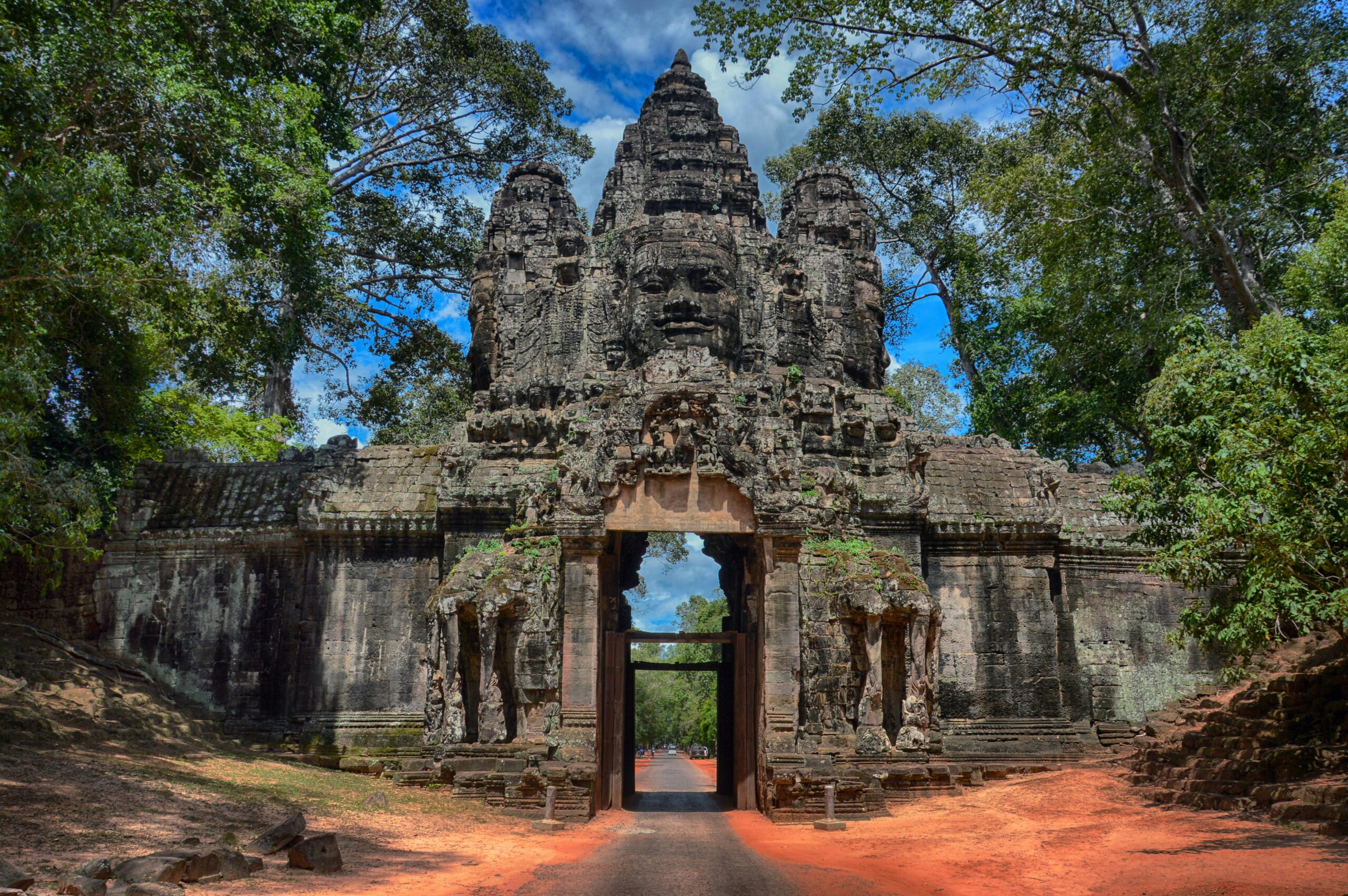 Angkor Wat travel guide: main causeway approach palm trees tourists Siem Reap Cambodia