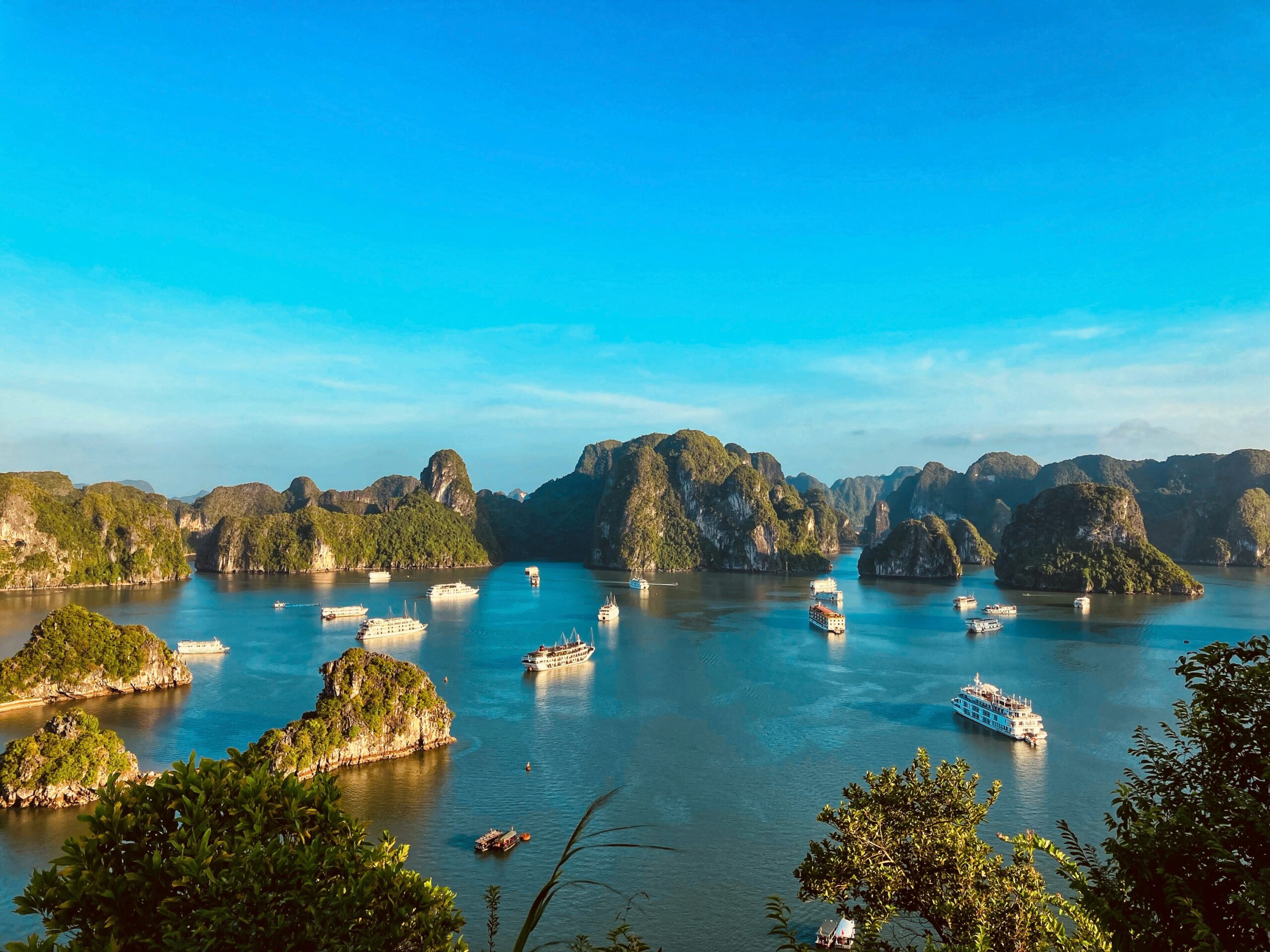 Ha Long Bay travel guide: aerial view limestone karst islands cruise boats UNESCO Vietnam