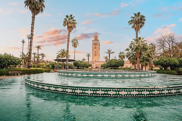 Marrakech travel guide: Koutoubia mosque minaret fountain palm trees at sunset