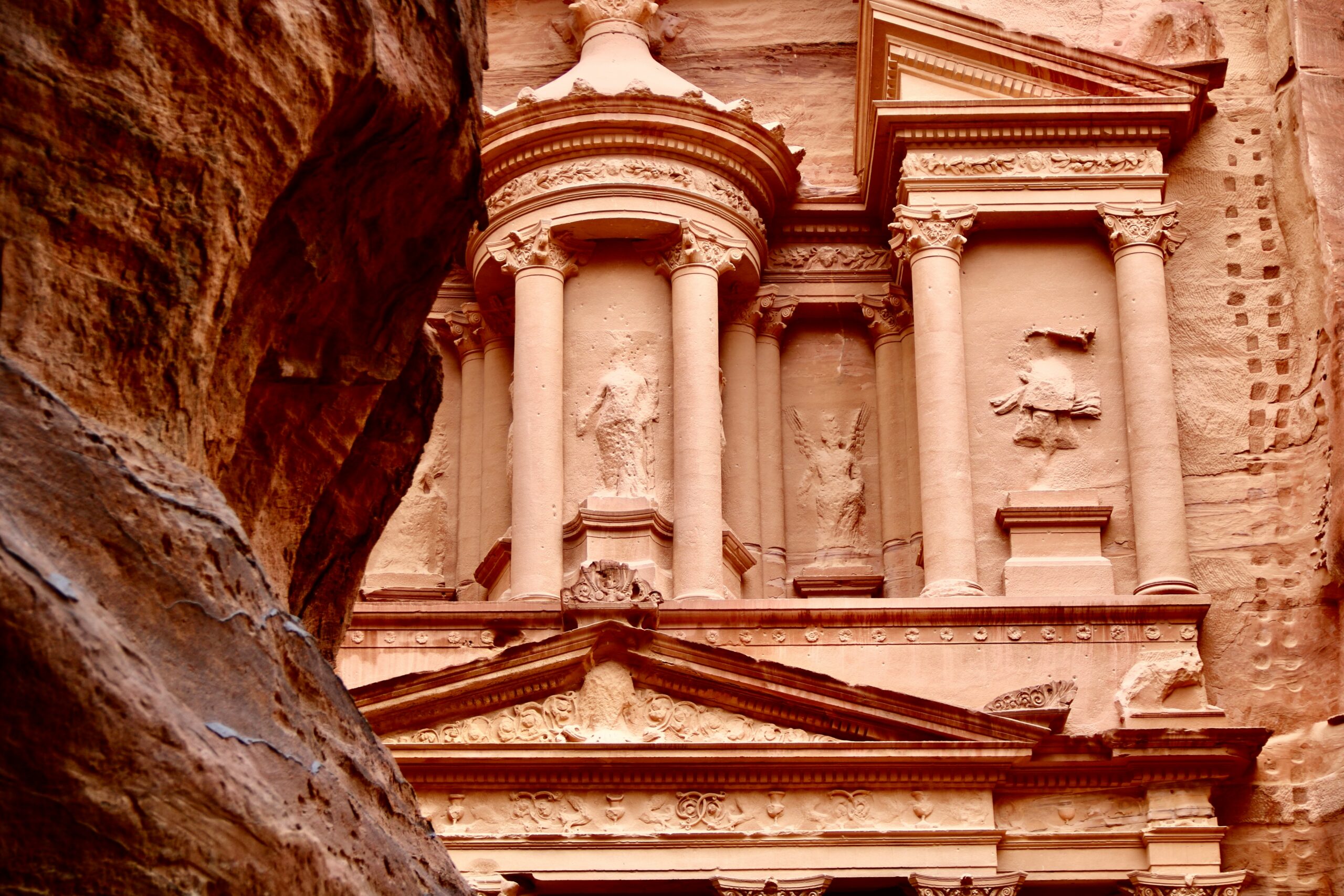 Petra Jordan travel guide: Treasury Al-Khazneh facade carved rock columns Siq