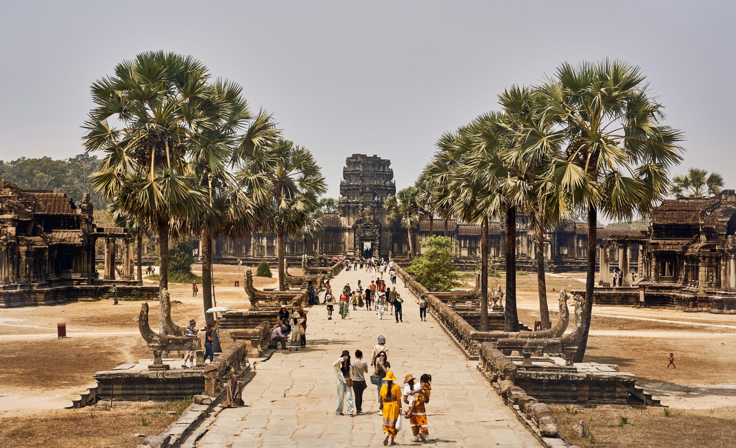 Angkor Wat travel guide: Angkor Thom South Gate stone faces tower jungle Cambodia